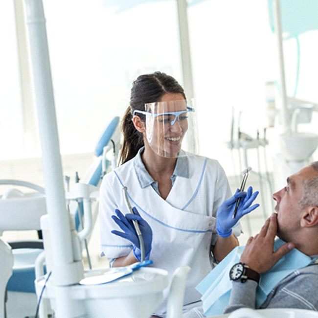 Dentist explaining how New You Dentures in Los Angeles work