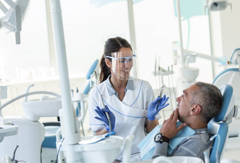 Dentist teaching patient about full mouth reconstruction in Van Nuys