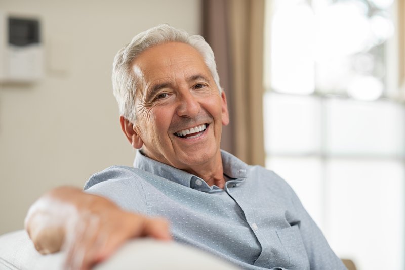 older person smiling after getting dental implants in Van Nuys