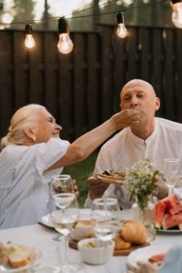 Woman feeding man food