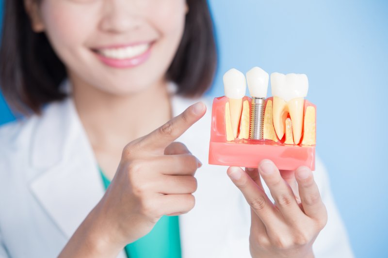 a dentist pointing at dental implants in Van Nuys